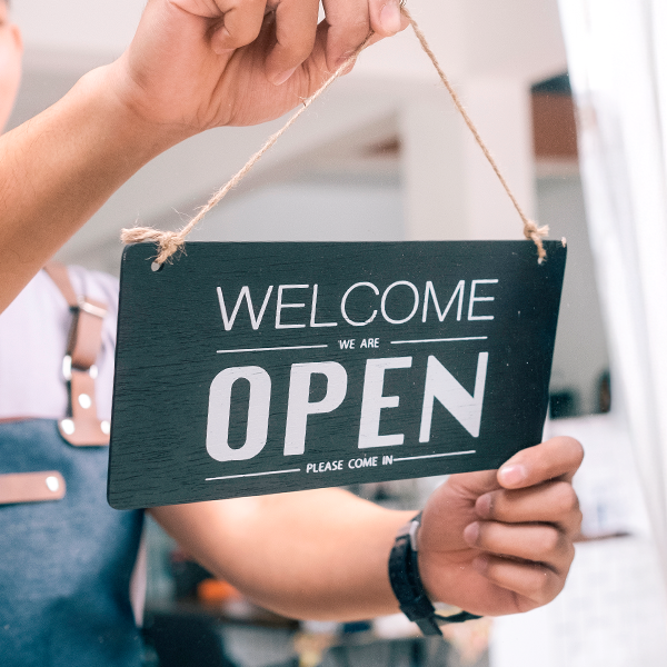 Welcome open sign at a local storefront