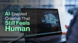 AI-enabled creative strategy displayed on a laptop screen with a neural network interface, representing human-centered marketing and brand identity.