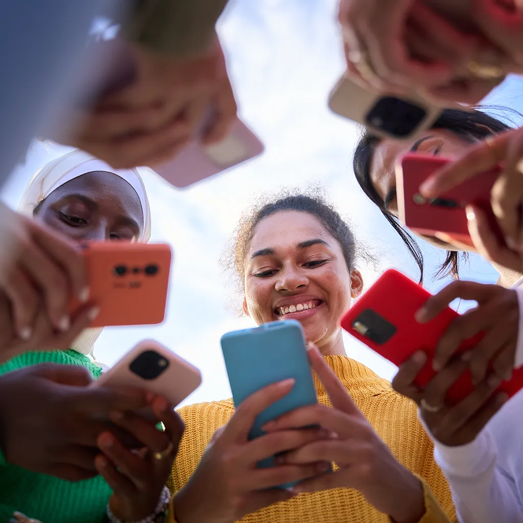 People using smartphones for social media engagement.